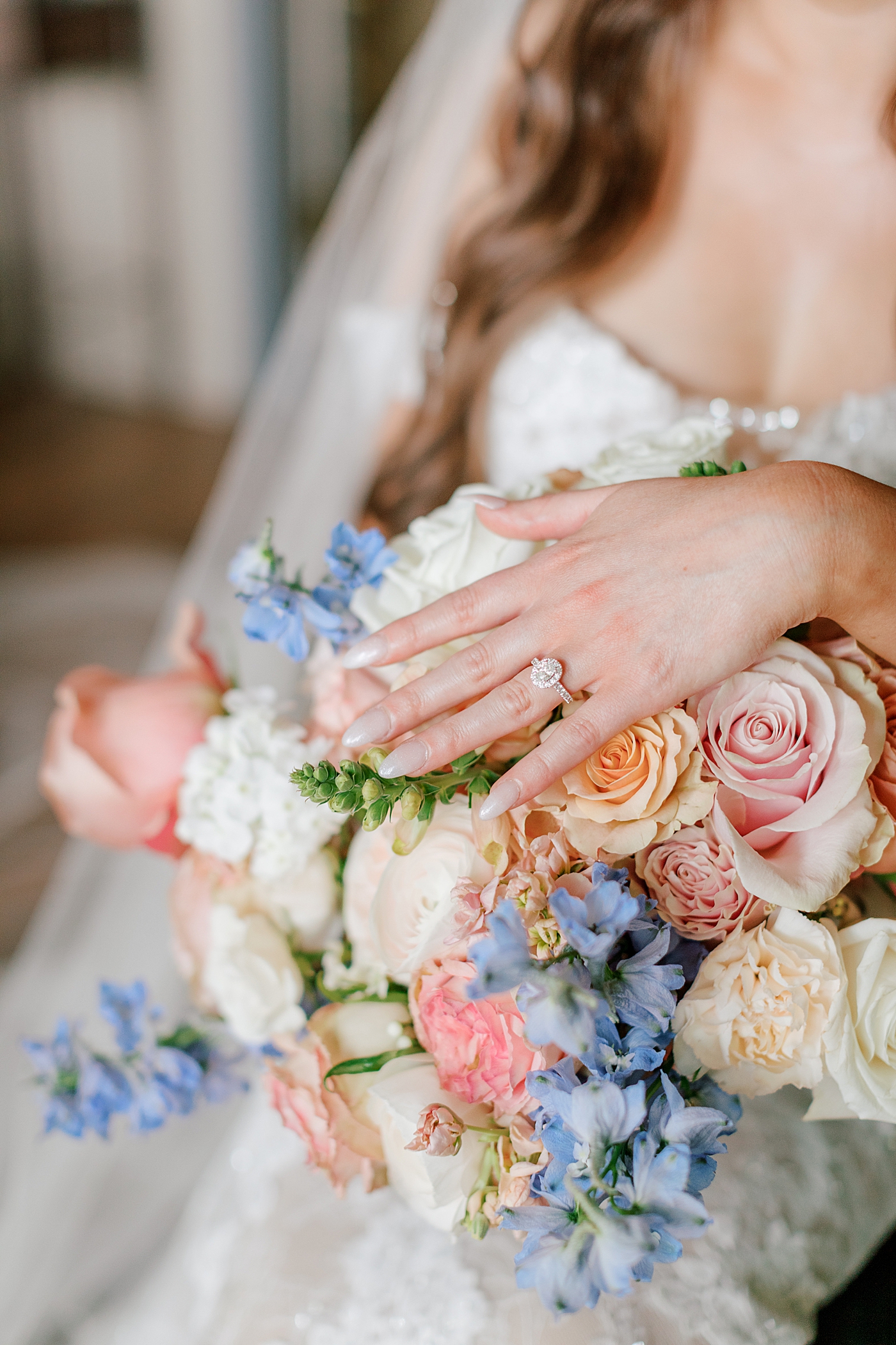 Details of bride's ring on her hand on her bouquet | Image by Hope Helmuth Photography 