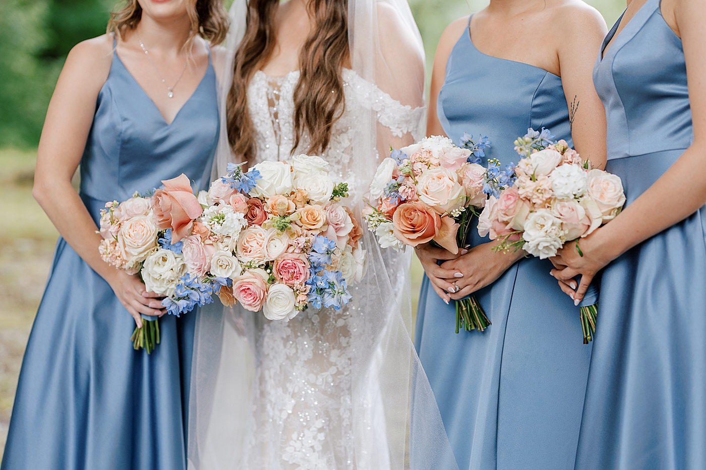 Detail of bride and bridesmaids holding their bouquets during Promise Ridge Wedding | Image by Hope Helmuth Photography 