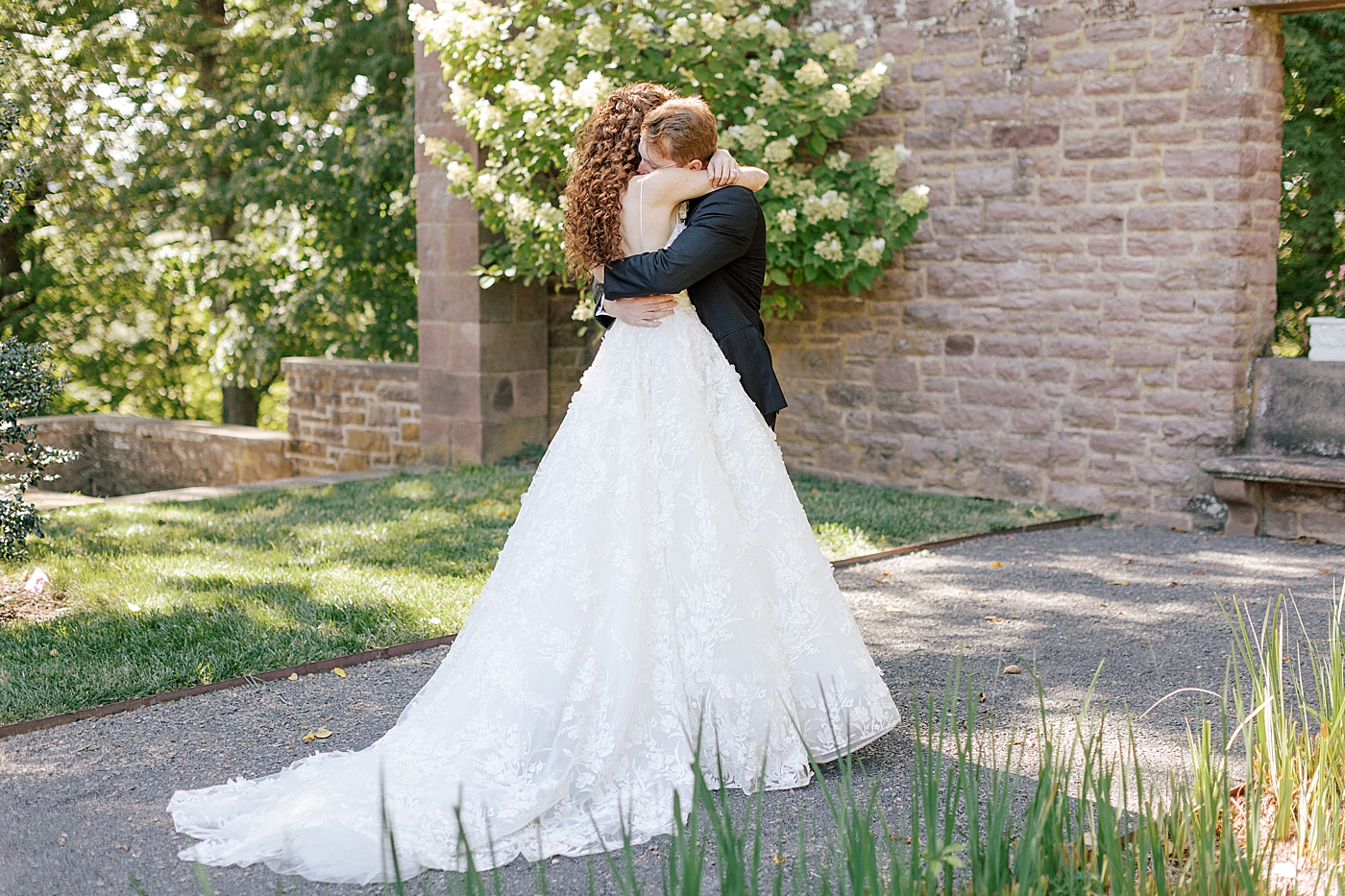 Bride and groom embracing at their first look during Tyler Gardens Wedding | Image by Hope Helmuth Photography