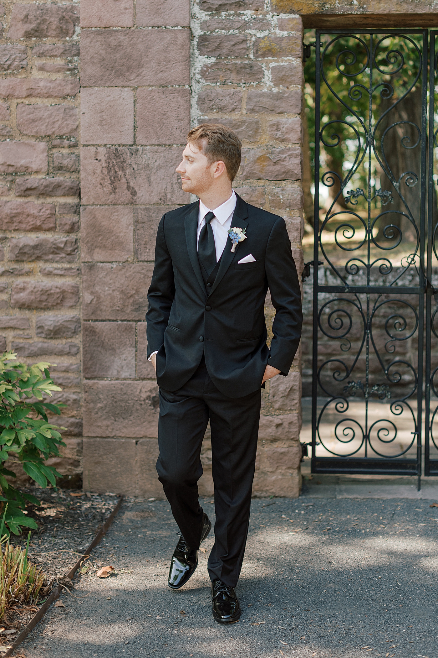 Groom walking towards the camera with hands in pockets during Tyler Gardens Wedding | Image by Hope Helmuth Photography