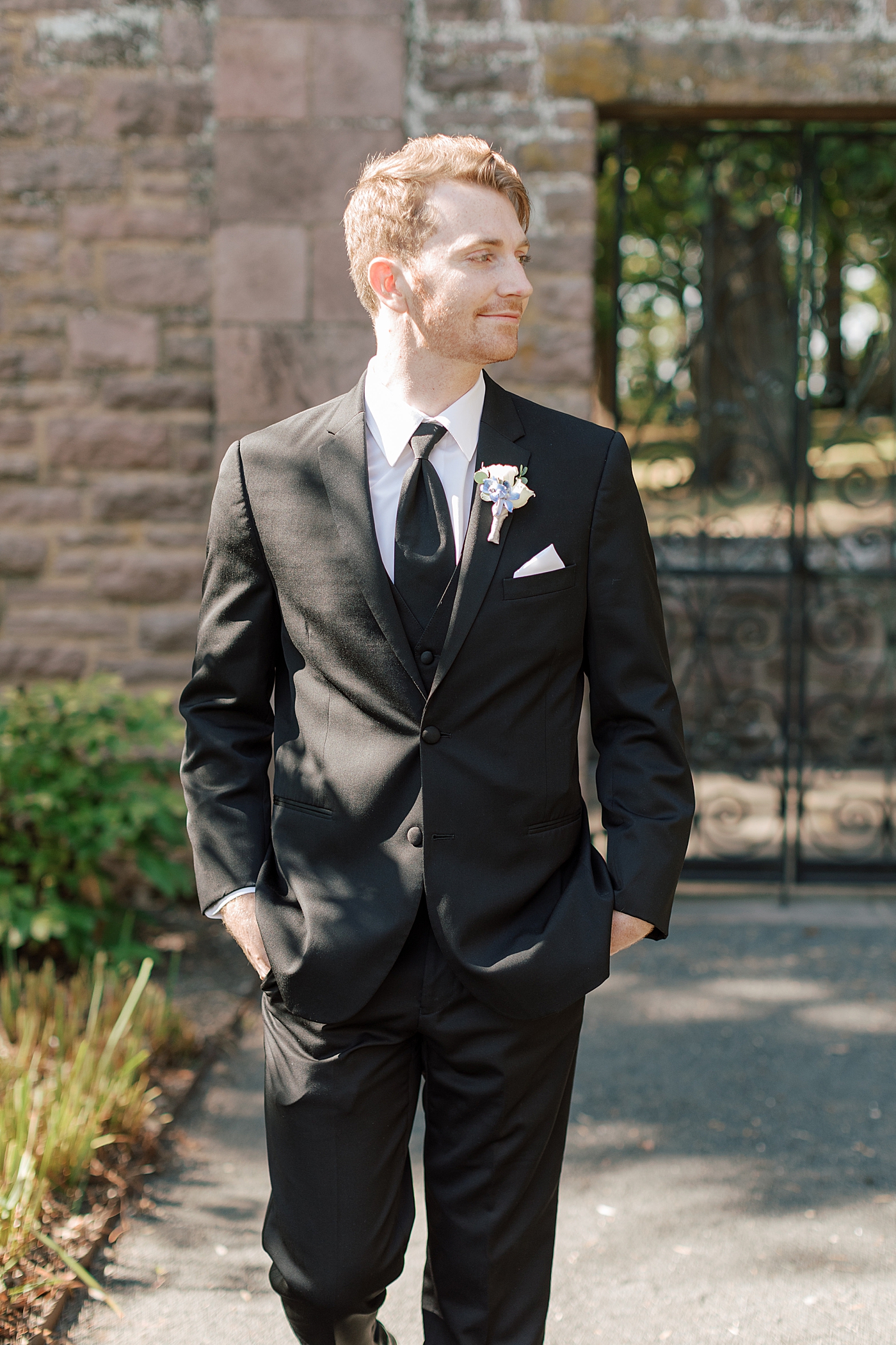 Groom walking towards the camera with hands in pockets during Tyler Gardens Wedding | Image by Hope Helmuth Photography
