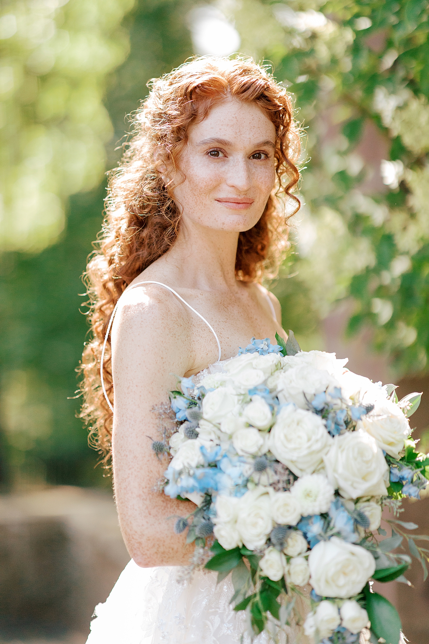 Bride posing with blue and white bouquet during Tyler Gardens Wedding | Image by Hope Helmuth Photography