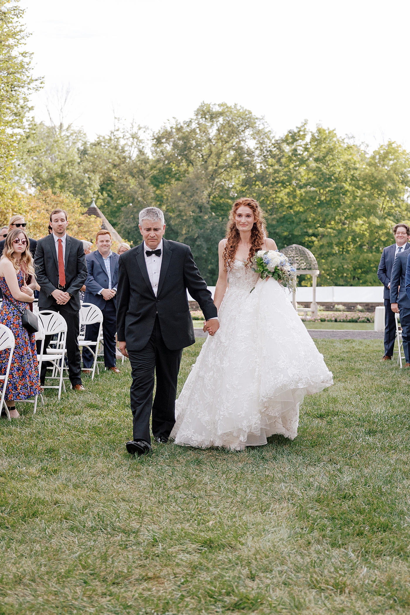 Father of bride and bride walking down the isle during Tyler Gardens Wedding | Image by Hope Helmuth Photography