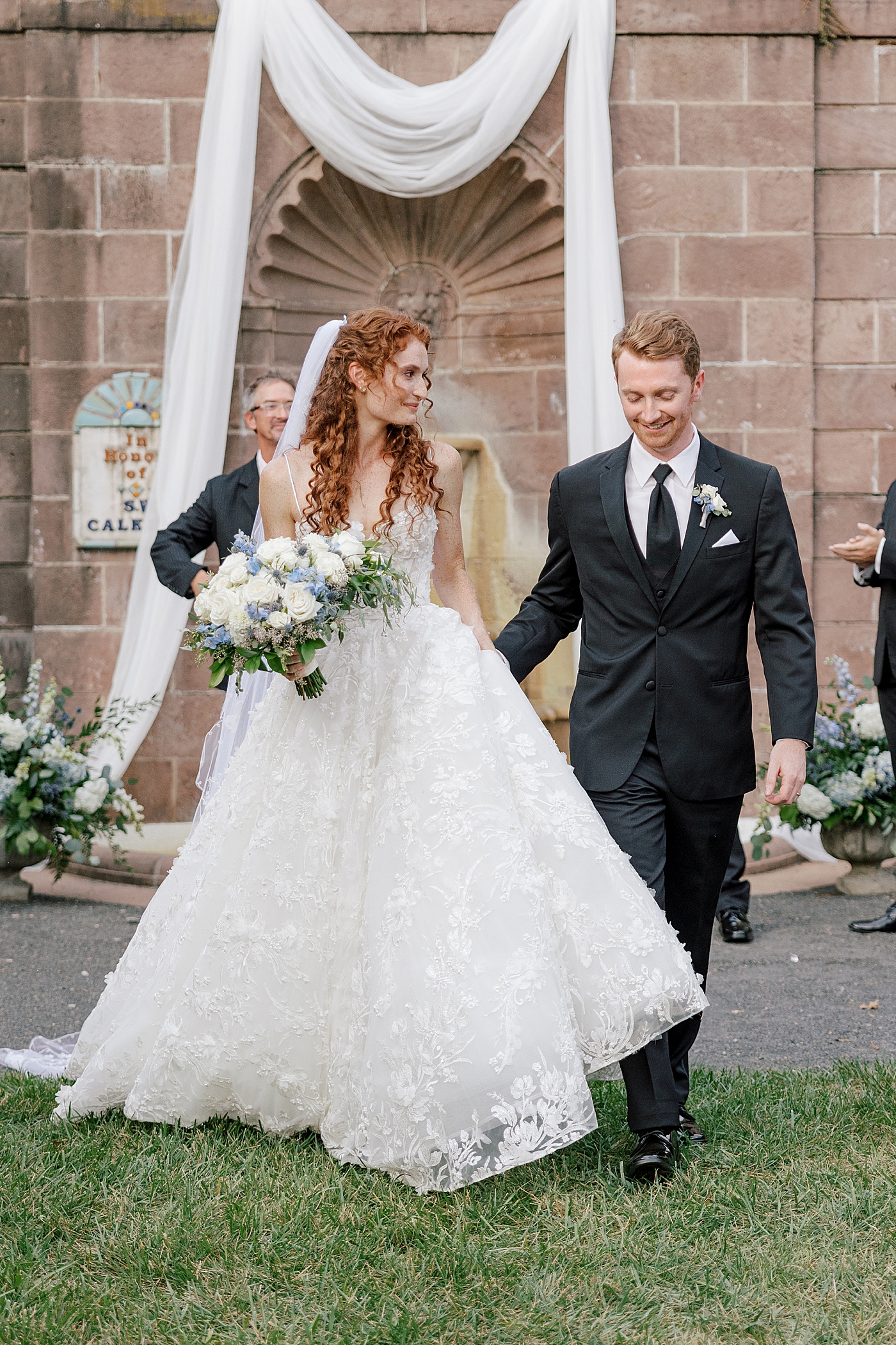 Bride and groom walking down the isle during Tyler Gardens Wedding | Image by Hope Helmuth Photography