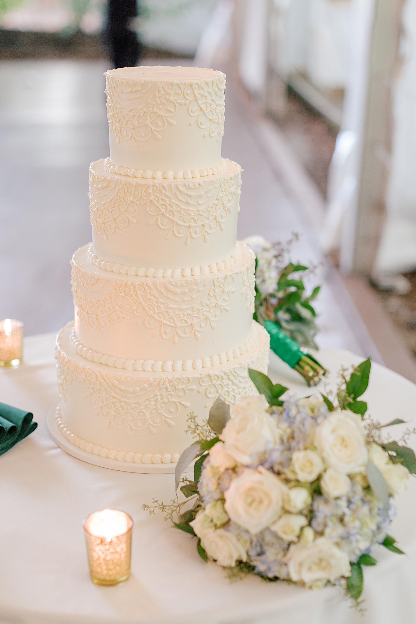 Green and white candlelit reception cake details during Tyler Gardens Wedding | Image by Hope Helmuth Photography
