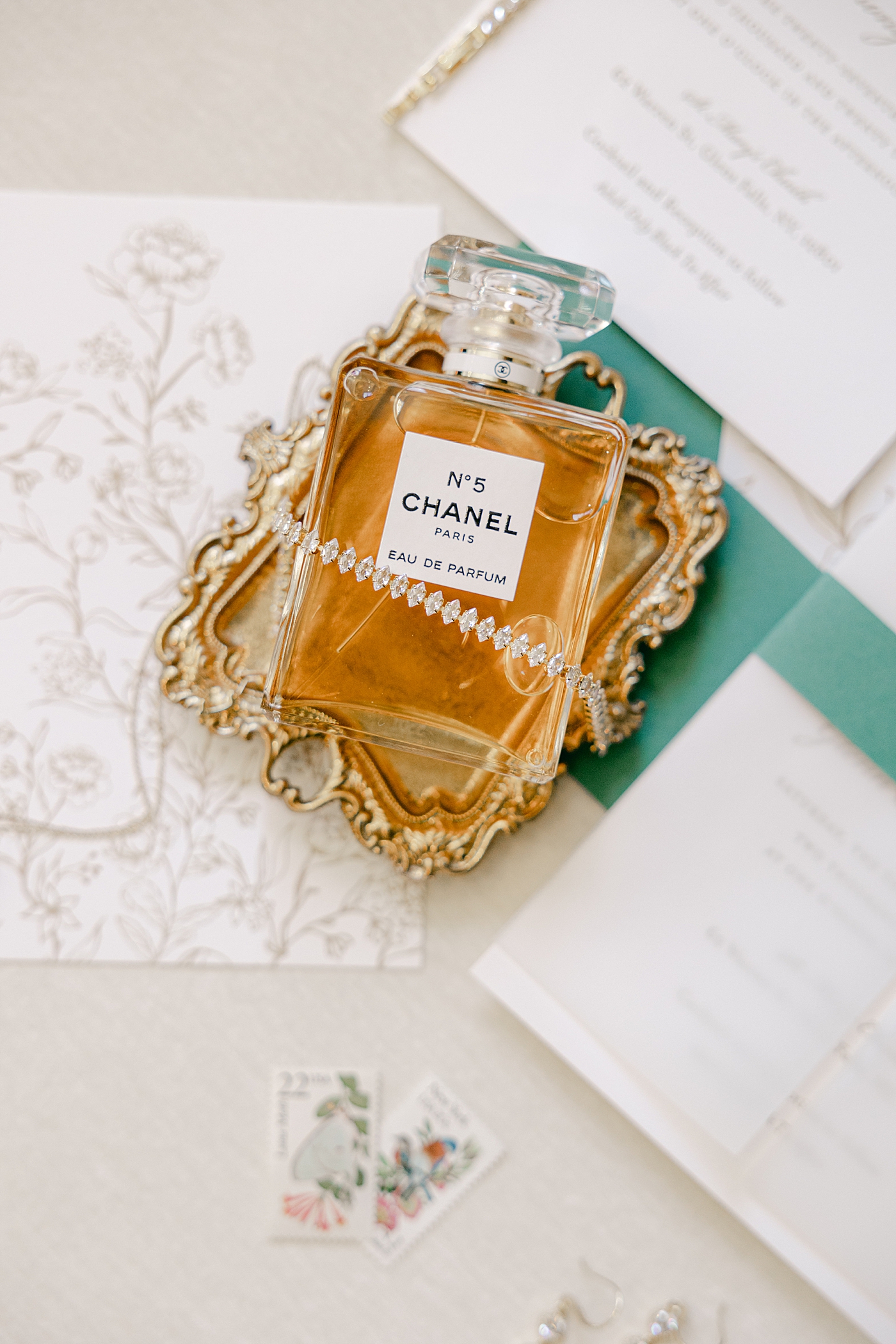 Wedding flat lay detail image of Chanel perfume during their Sagamore Wedding | Image by Hope Helmuth Photography