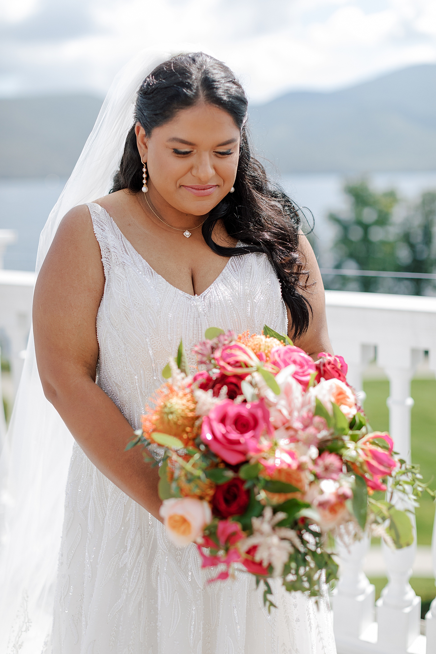 Close up bridal portrait with veil and colorful bridal bouquet | Image by Hope Helmuth Photography