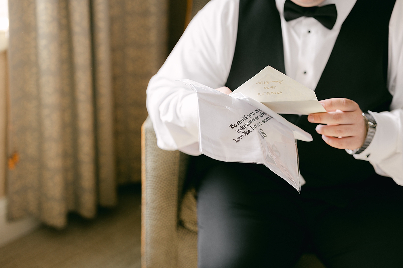 Detail image of a groom reading a letter from his bride  | Image by Hope Helmuth Photography