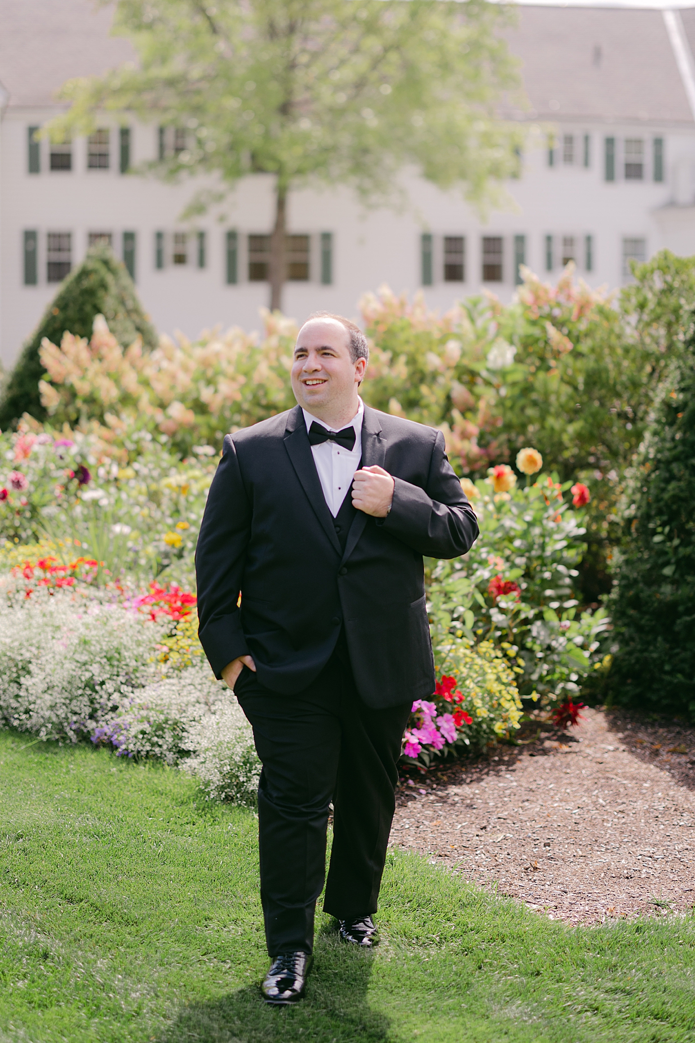 Formal portrait of a groom by himself looking away from the camera | Image by Hope Helmuth Photography
