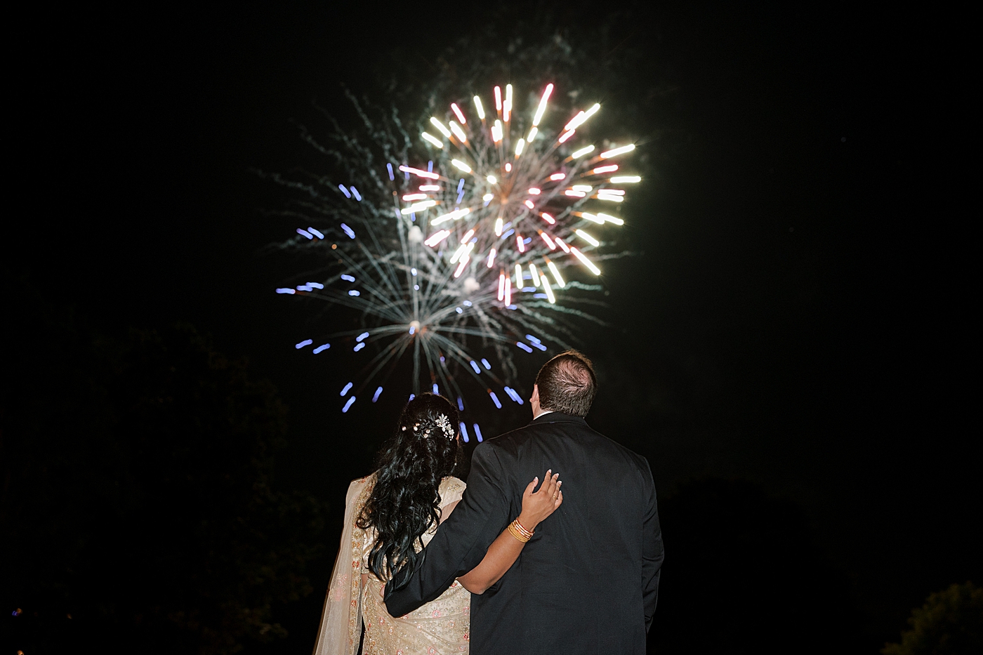 Bride and groom watching fireworks during their Sagamore Wedding | Image by Hope Helmuth Photography