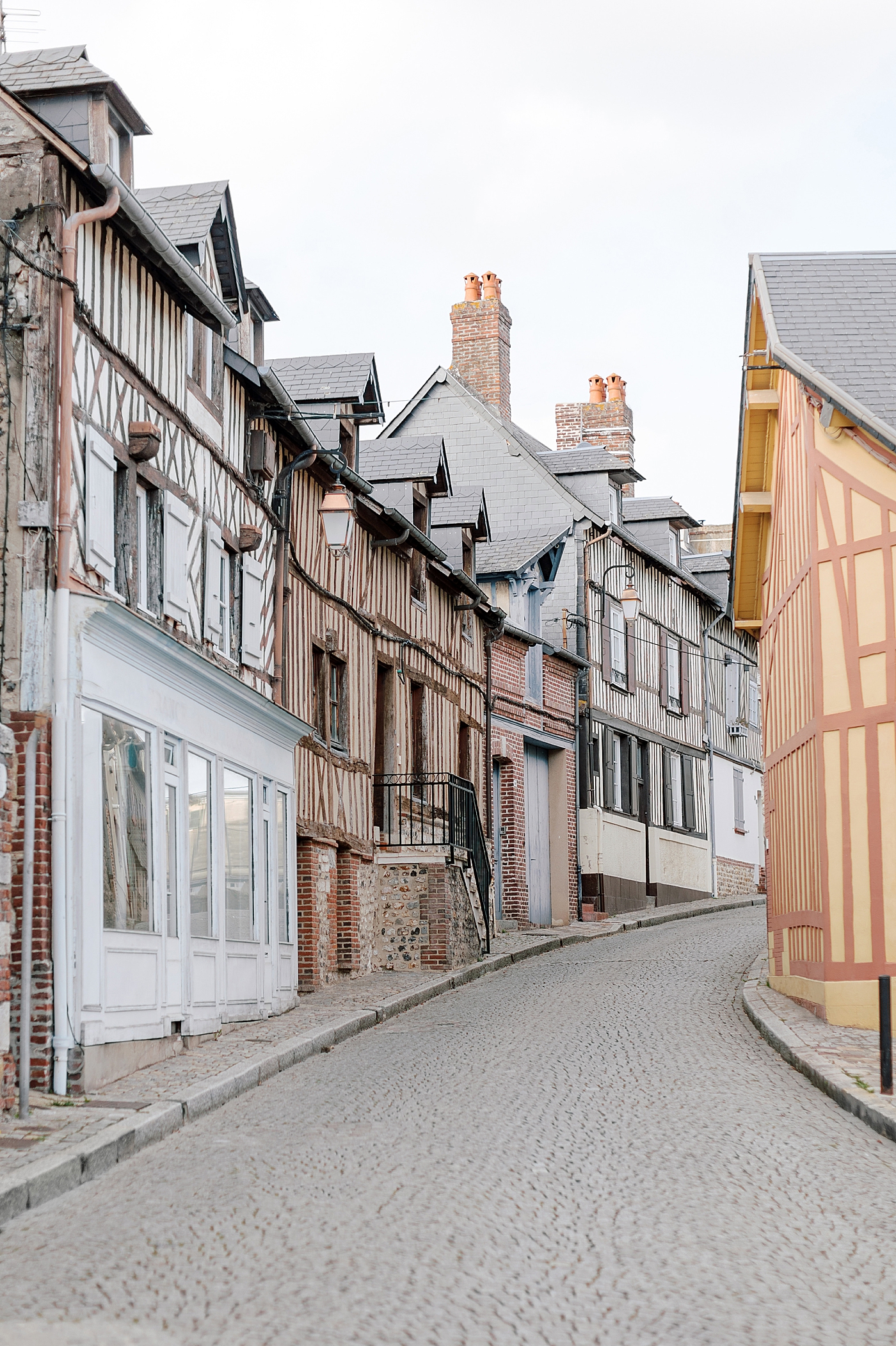 View of a French cobblestone street of homes | Image by Hope Helmuth Photography