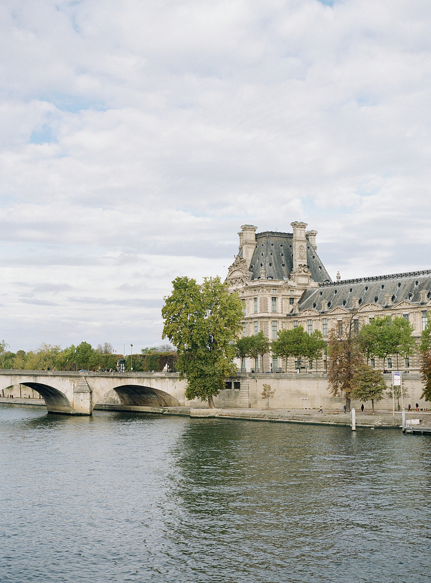 French building across a canal with a bridge | Image by Hope Helmuth Photography