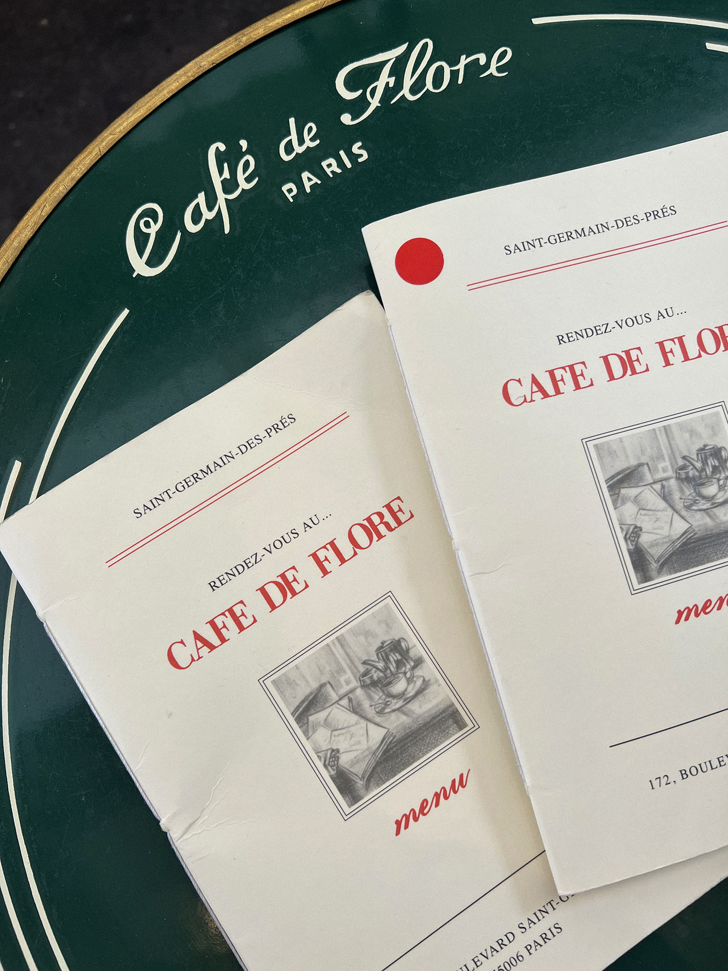 Menus from a French restaurant on a cafe table