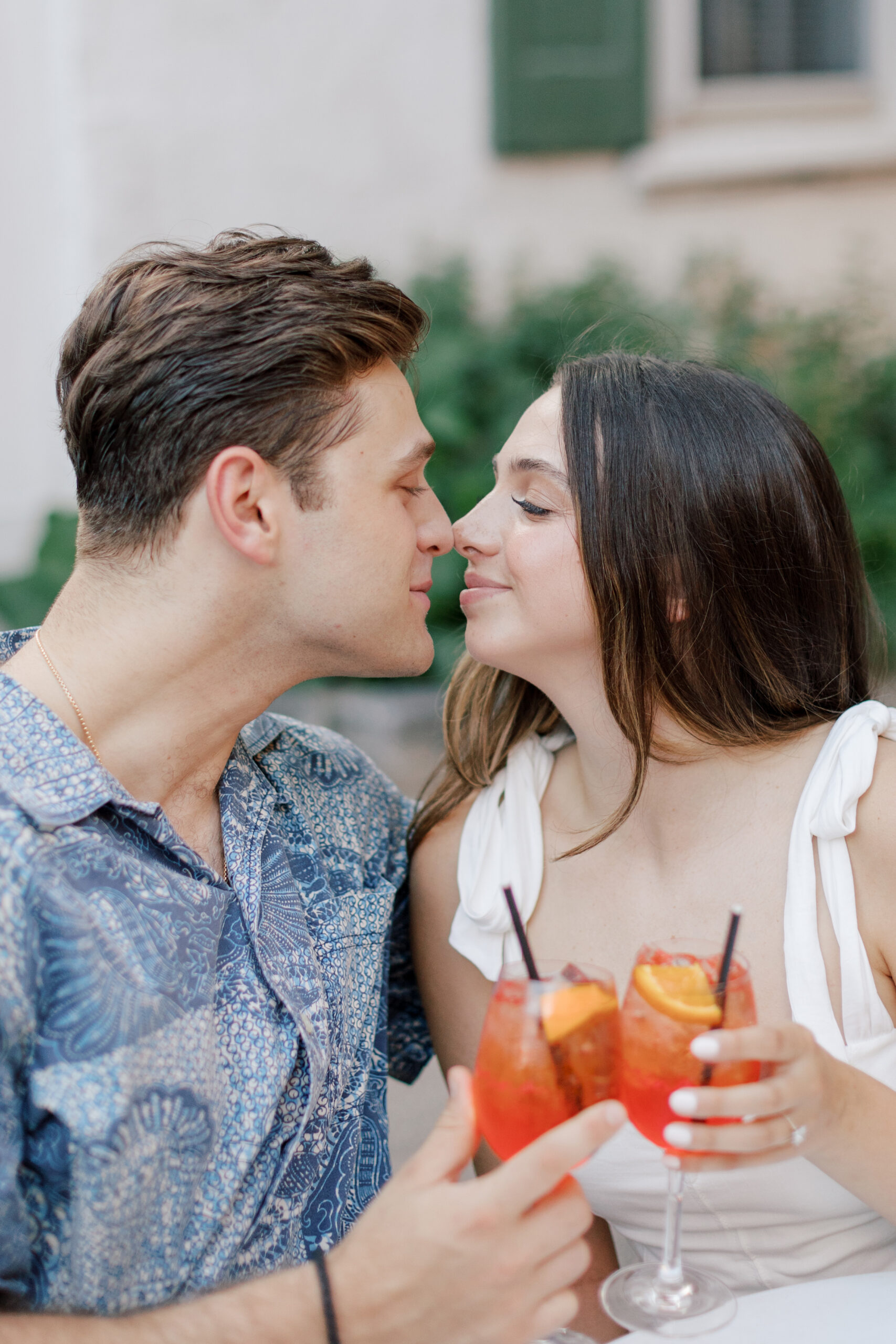 Couple with their noses touching with Aperol sprits | Image by Hope Helmuth Photography