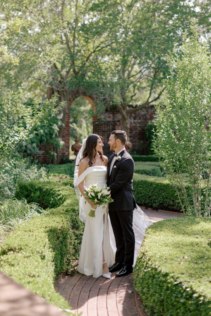 Bride walking through the gardens at Tryon Palace in her classic gown during a North Carolina wedding