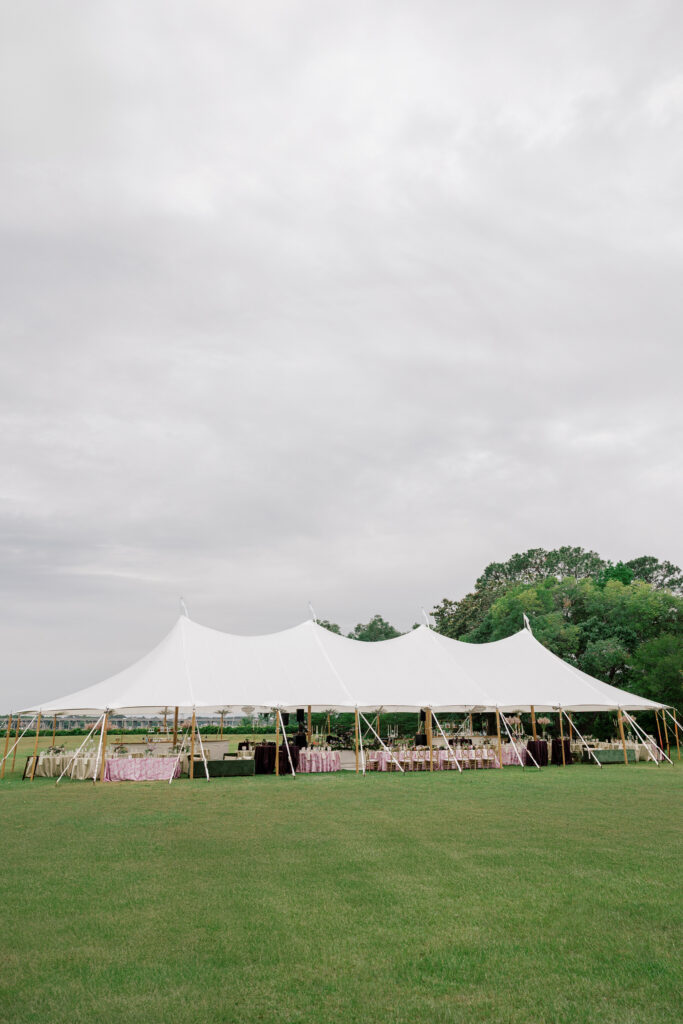 Tented reception setup with sage, purple, and blush details at a spring North Carolina wedding