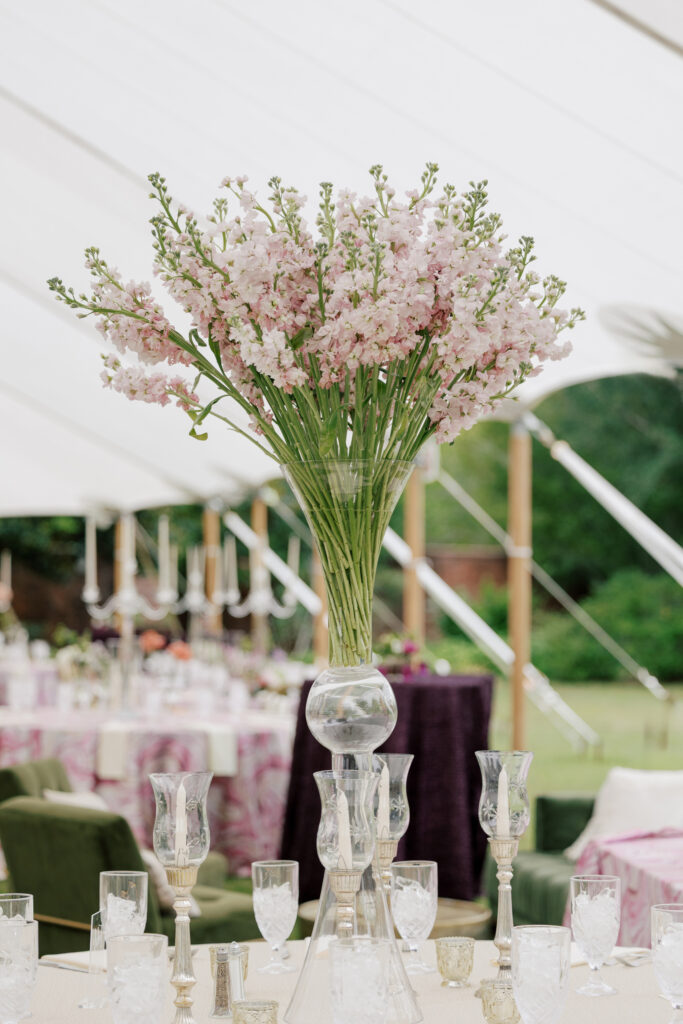Tented reception setup with sage, purple, and blush details at a spring North Carolina wedding