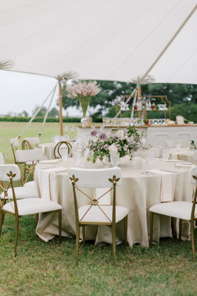 Tented reception setup with sage, purple, and blush details at a spring North Carolina wedding