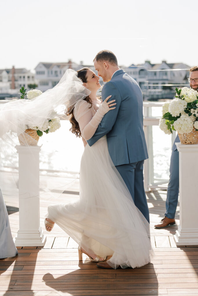 The Reeds at Shelter Haven wedding ceremony with white hydrangeas on the bay in Stone Harbor