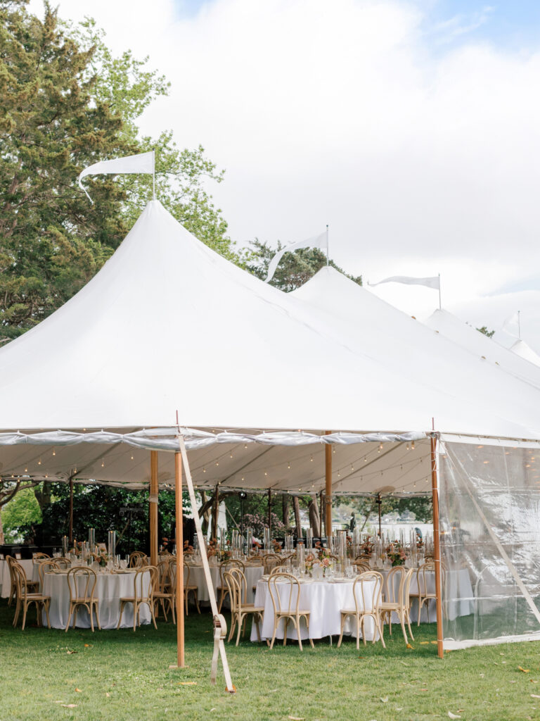 Sailcloth tented reception setup at Hermitage Museum wedding with colorful floral arrangements.