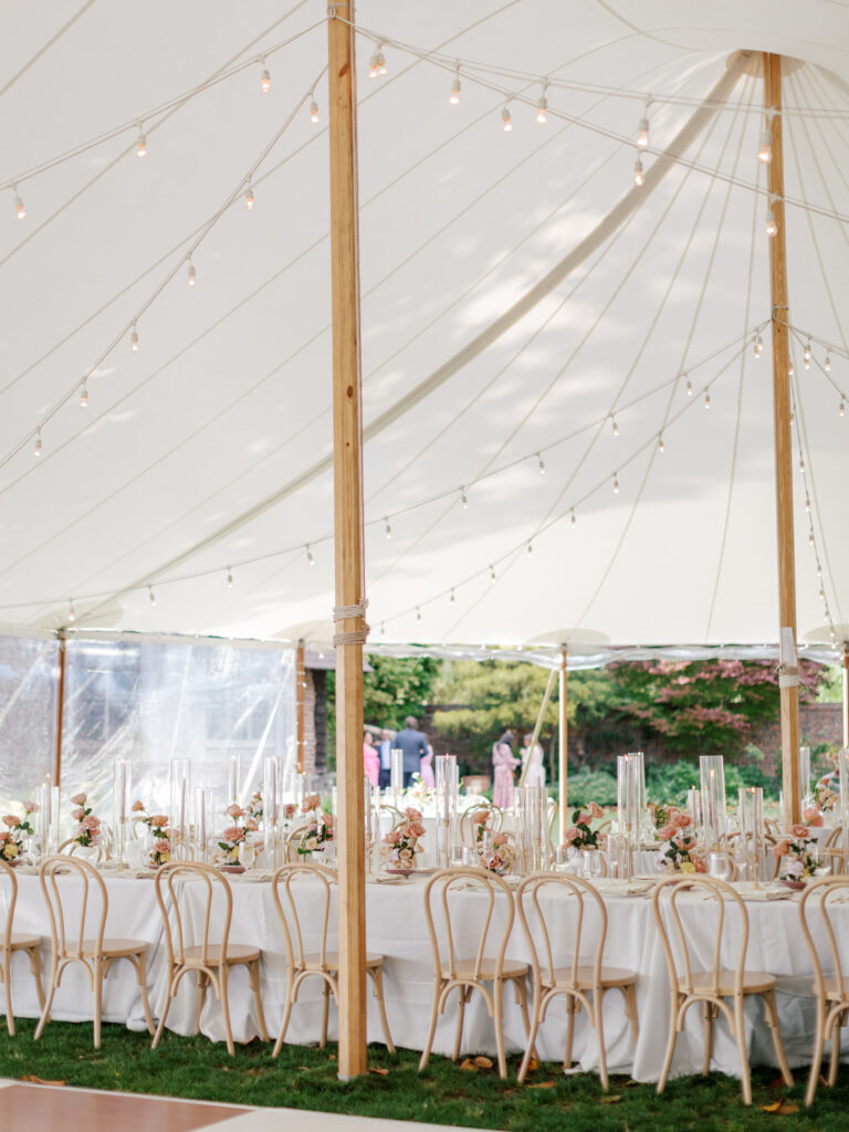 Sailcloth tented reception setup at Hermitage Museum wedding with colorful floral arrangements.