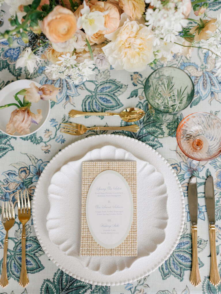 Pastel tablescape with custom menus and fine papergoods at an intimate luxury destination wedding reception