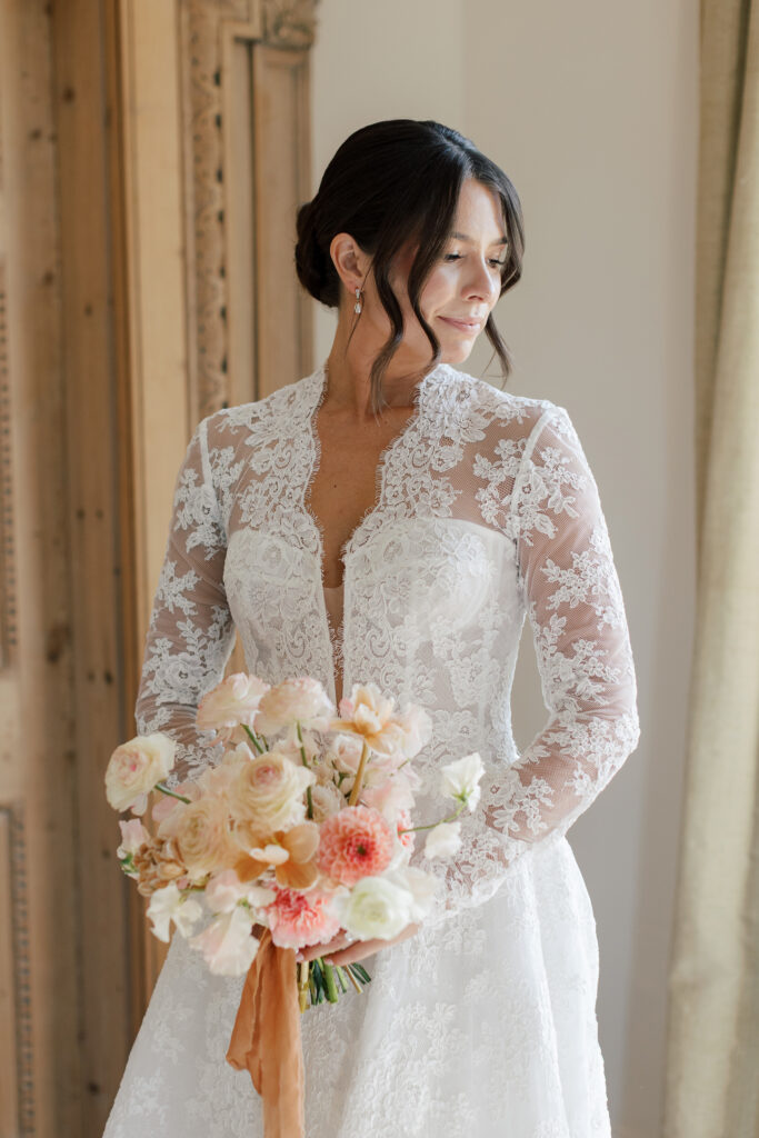 bride in lace wedding gown and garden floral bouquet